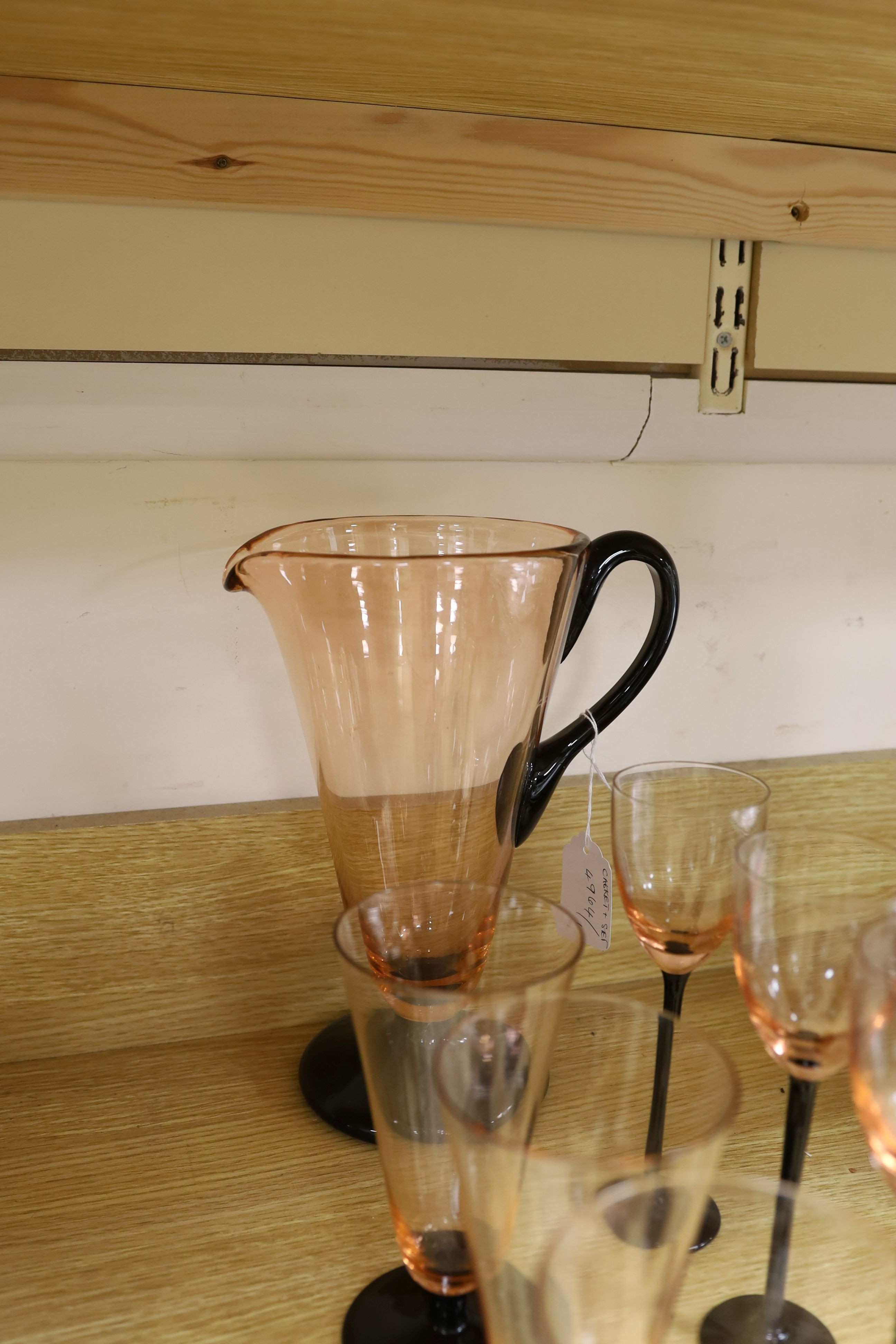 A Bohemian ruby glass casket and an Art Deco style part lemonade set in black and pink glass (14 glasses and a jug)